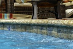 MS-886-in-spa-and-spill-over-IS-637-waterline-Scabos-Coping-and-2x4-Splitface-by-Grotto-Pools.5-scaled